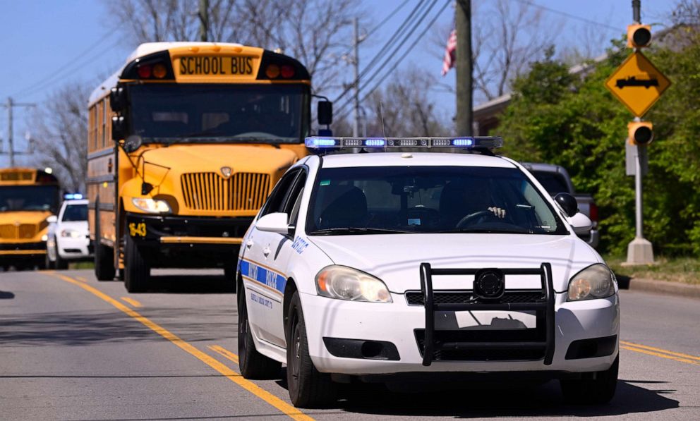 PHOTO: Metro Nashville Police cars escort evacuees from the school and church on schools buses as they leave Covenant School, Covenant Presbyterian Church, in Nashville, Tenn., Mar. 27, 2023.