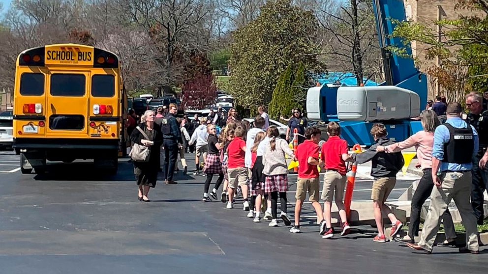 PHOTO: Children from The Covenant School, a private Christian school in Nashville, Tenn., hold hands as they are taken to a reunification site after a deadly shooting at their school, March 27, 2023.