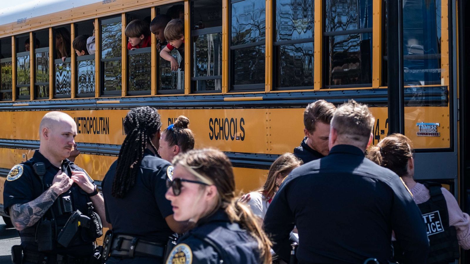 PHOTO: School buses with children arrive at Woodmont Baptist Church to be reunited with their families after a mass shooting at The Covenant School, Mar. 27, 2023, in Nashville, Tenn.