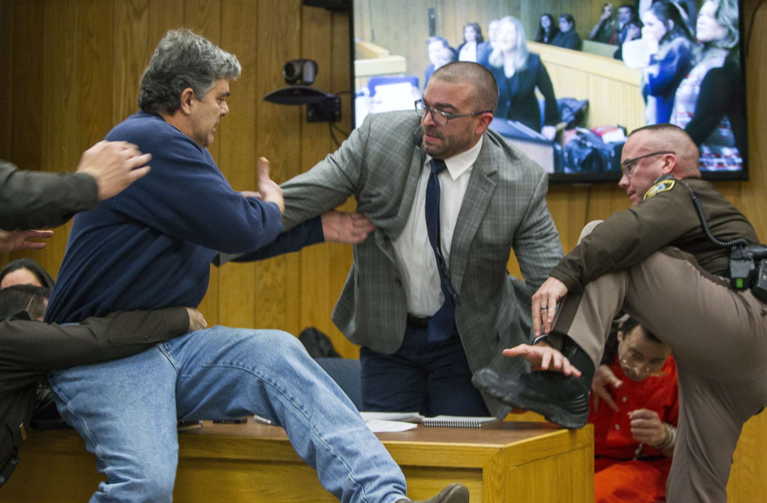 PHOTO: Randall Margraves, father of three victims of Larry Nassar, left, lunges at Nassar, bottom right, Feb. 2, 2018, in Eaton County Circuit Court in Charlotte, Mich.