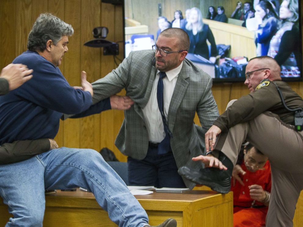 PHOTO: Randall Margraves, father of three victims of Larry Nassar, left, lunges at Nassar, bottom right, Feb. 2, 2018, in Eaton County Circuit Court in Charlotte, Mich.