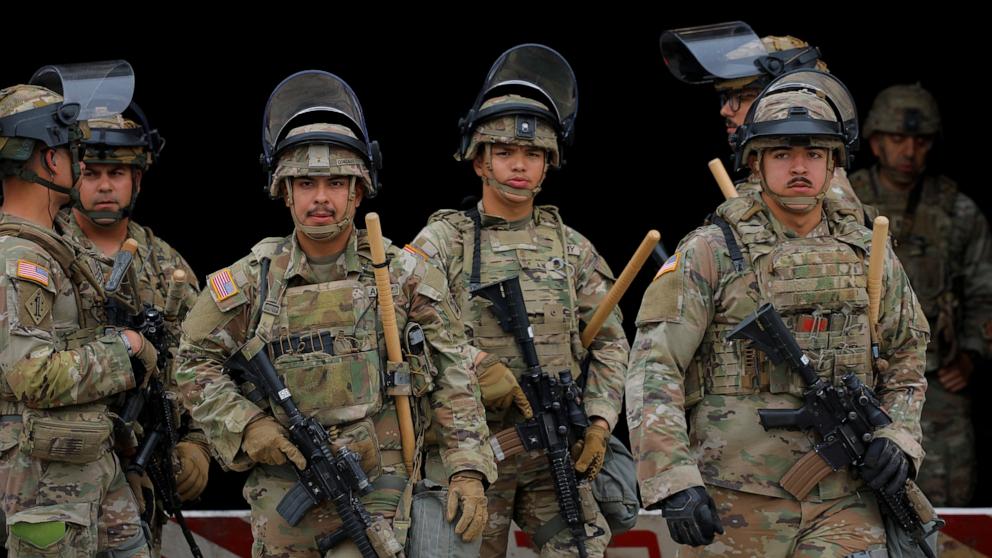 PHOTO: Members of the California National Guard stand outside the Edward R. Roybal federal building after their deployment by President Donald Trump, in response to protests against immigration sweeps, in Los Angeles.