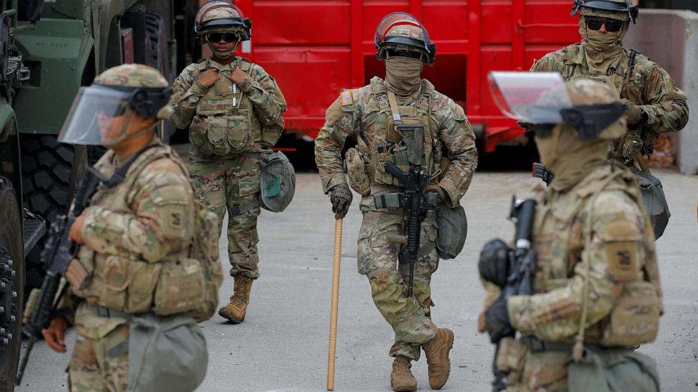 PHOTO: Members of the California National Guard stand outside the Edward R. Roybal federal building after their deployment by U.S. President Donald Trump, in response to protests against immigration sweeps, in Los Angeles, June 8, 2025.