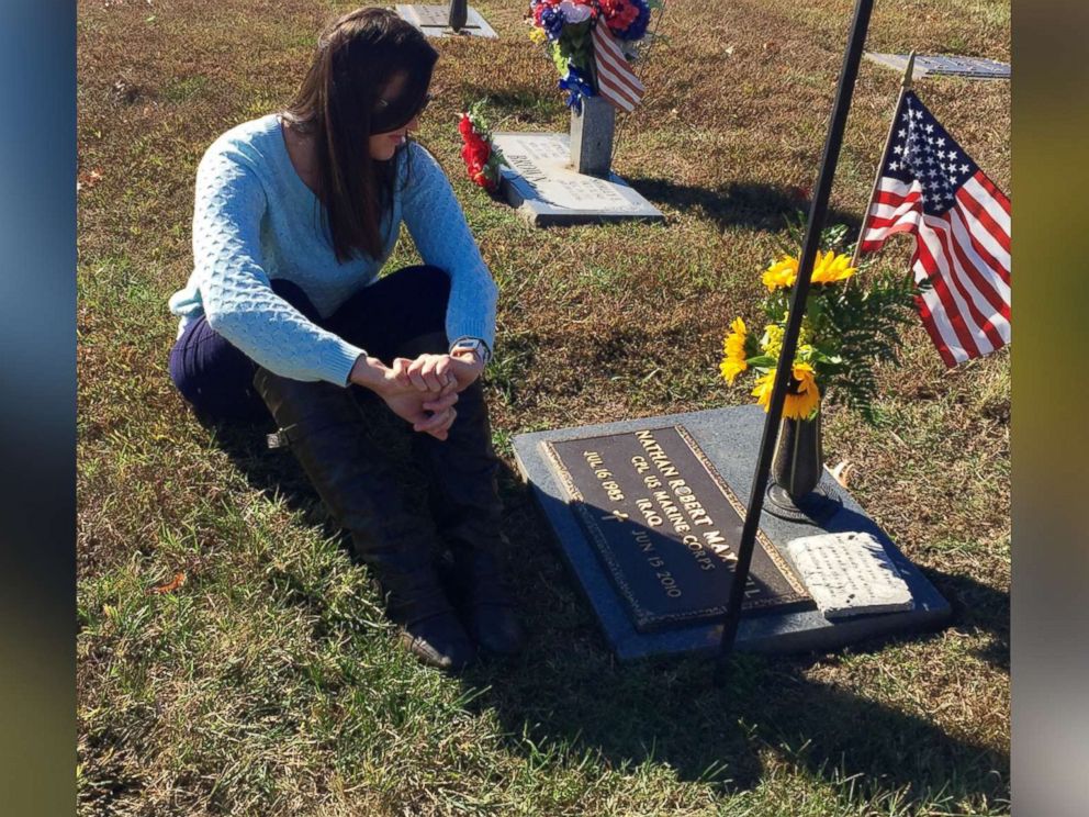 PHOTO: Kylynn Maxwell sits at her late husband Marine Corporal Nathan Maxwells grave site.