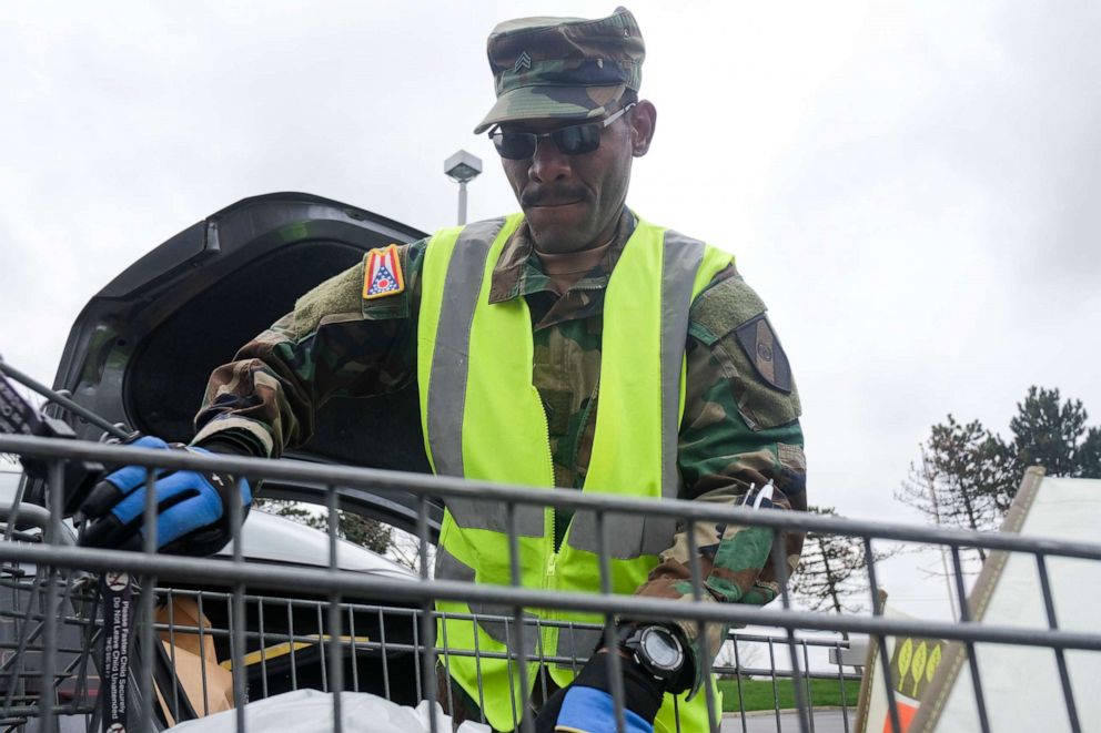 PHOTO: A member of the Ohio National Guard helps to pack food and supplies for those in need at the Mid Ohio Foodbank in Columbus.