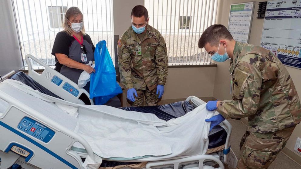 PHOTO: Certified nursing assistant Cheri Knott teaches room cleaning protocols to Pvt. Aaron Marton and Spc. Jeremy Roe of 1st Battalion, 186th Infantry Regiment, Oregon National Guard, at Mercy Medical Center in Roseburg, Oregon, Aug. 21, 2021.