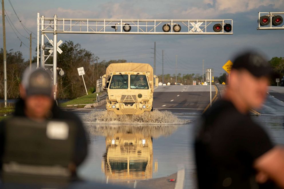 PHOTO: A National Guard vehicle drives through floodwaters from the Peace River on October 4, 2022 in Arcadia, Florida. 