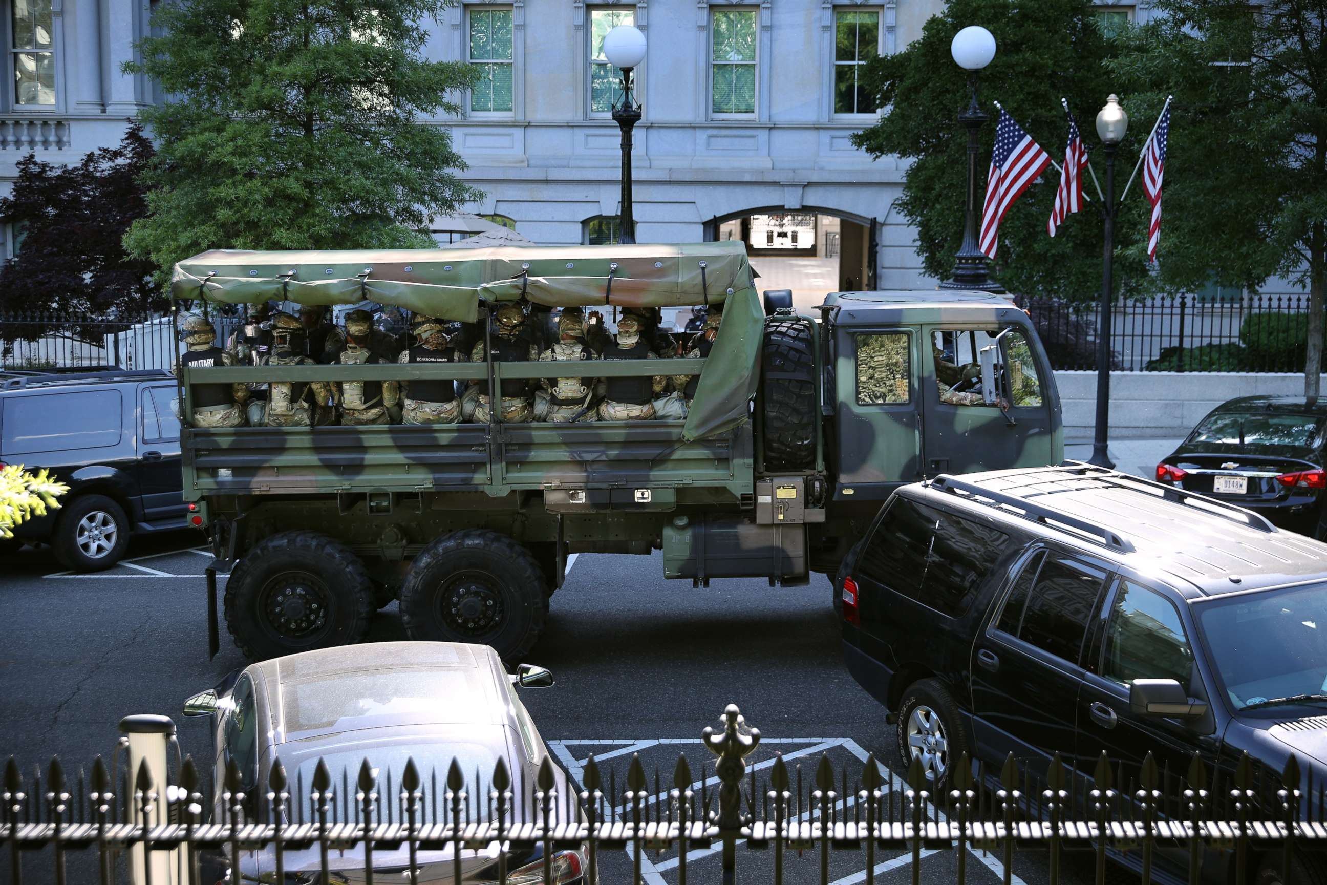 PHOTO: Trucks transport District of Columbia National Guard troops along West Executive Drive in support of law enforcement officers that are keeping demonstrators away from the White House, June 01, 2020, in Washington.