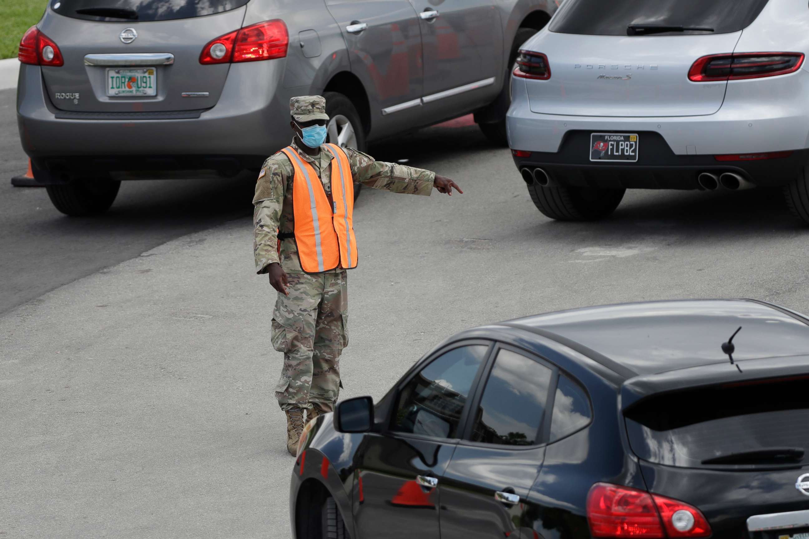 PHOTO: A National Guardsman directs traffic at a drive-thru COVID-19 testing site outside Hard Rock Stadium in Miami Gardens, Florida, on July 8, 2020. Florida has become one of the nation's hot spots for the novel coronavirus.