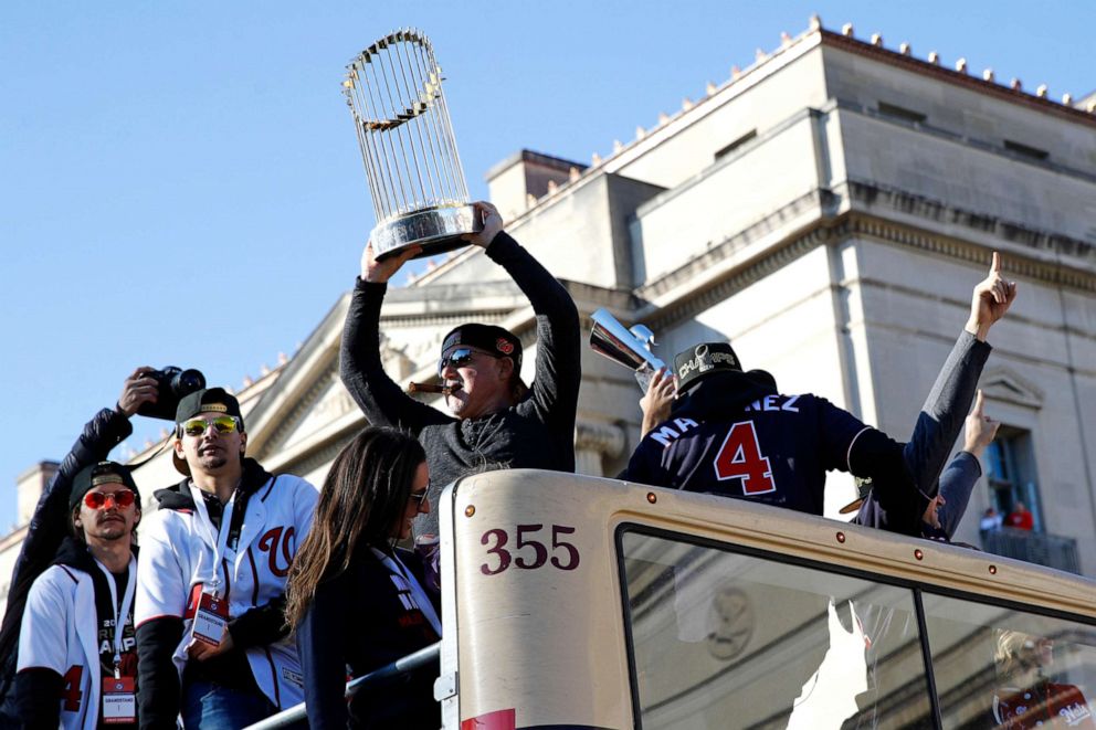PHOTO: Washington Nationals general manager Mike Rizzo holds up the World Series trophy during a parade to celebrate the team's World Series baseball championship over the Houston Astros, Saturday, Nov. 2, 2019, in Washington.