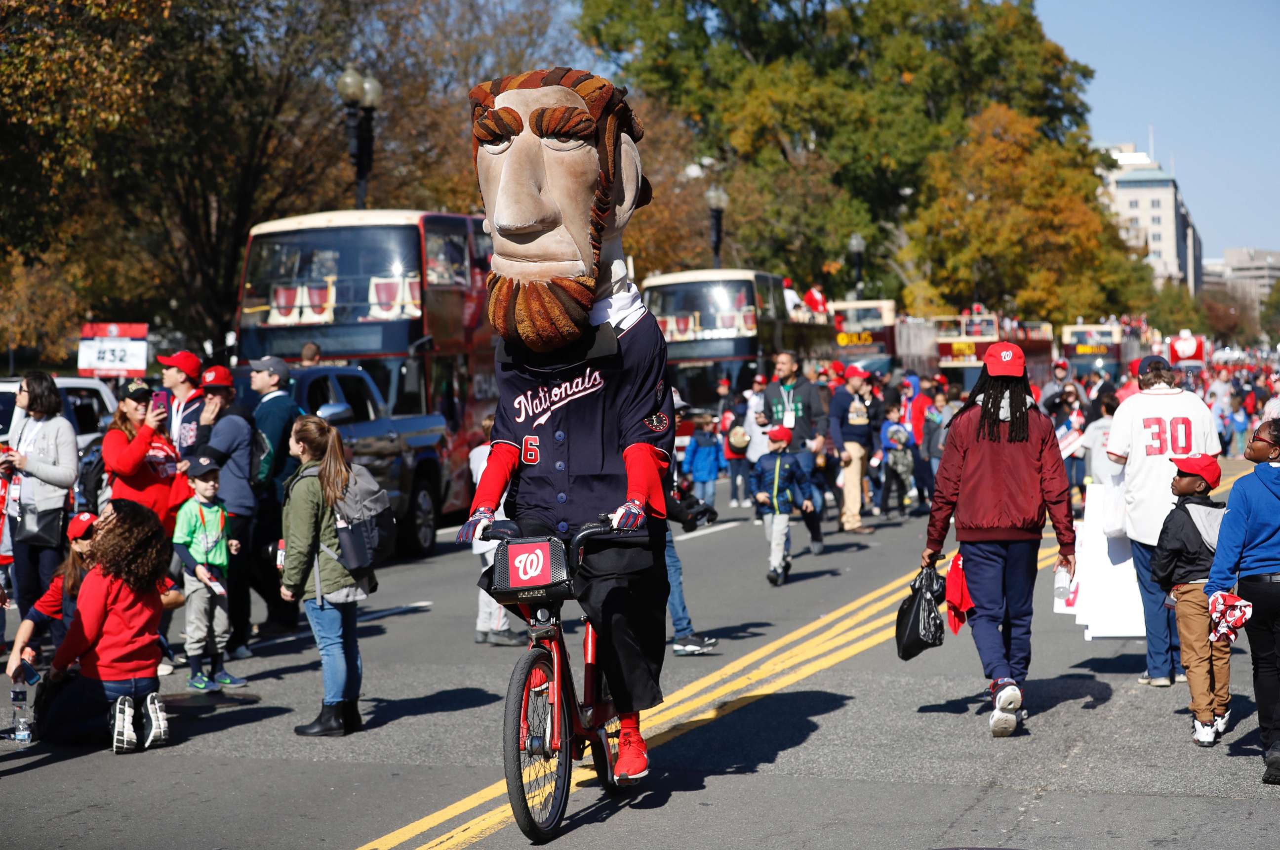 PHOTO: The Washington Nationals president mascot rides a bike before the start of the World Series championship parade in downtown Washington, DC.
