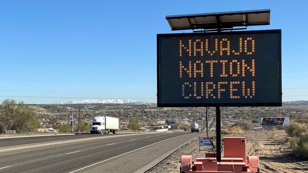 PHOTO: A road sign outside Bloomfield, N.M., warns Navajos to stay home during their nation's 8 p.m. to 5 a.m. curfew to slow the spread of the coronavirus, on April 7, 2020. 