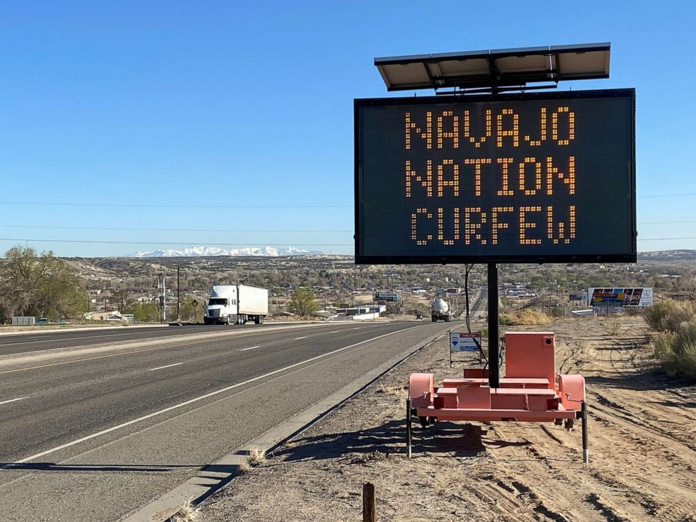 PHOTO: A road sign outside Bloomfield, N.M., warns Navajos to stay home during their nation's 8 p.m. to 5 a.m. curfew to slow the spread of the coronavirus, on April 7, 2020. 