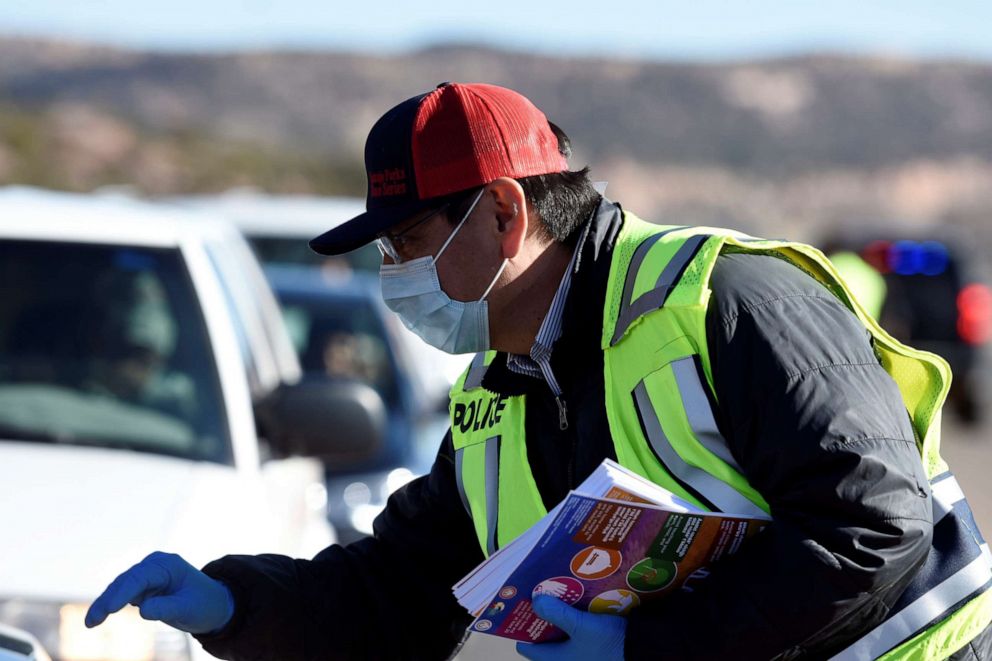 PHOTO: Navajo Nation President Jonathan Nez distributes educational material to drivers on how to prevent the spread of the novel coronavirus at a checkpoint in Window Rock, Arizona, on March 24, 2020.