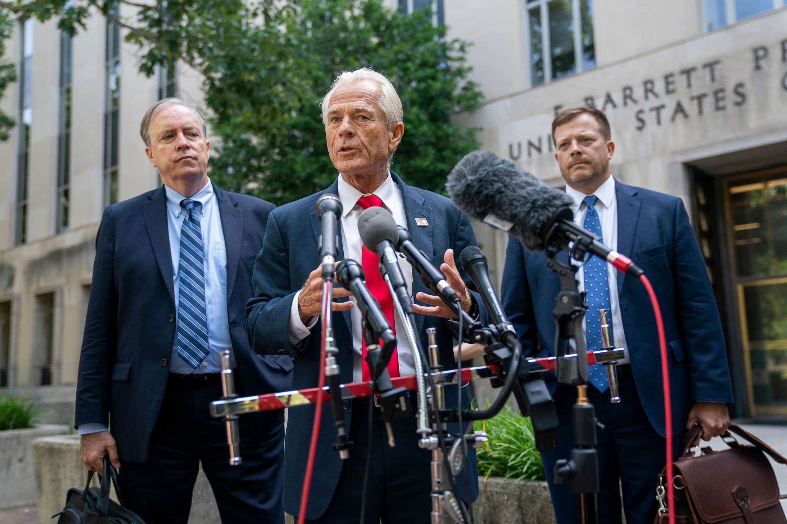 PHOTO: Former Trump administration trade adviser Peter Navarro, with his attorneys John Rowley, left, and John Irving, right, makes a statement to the media following a court appearance at the US District Court in Washington, DC, June 17, 2022.