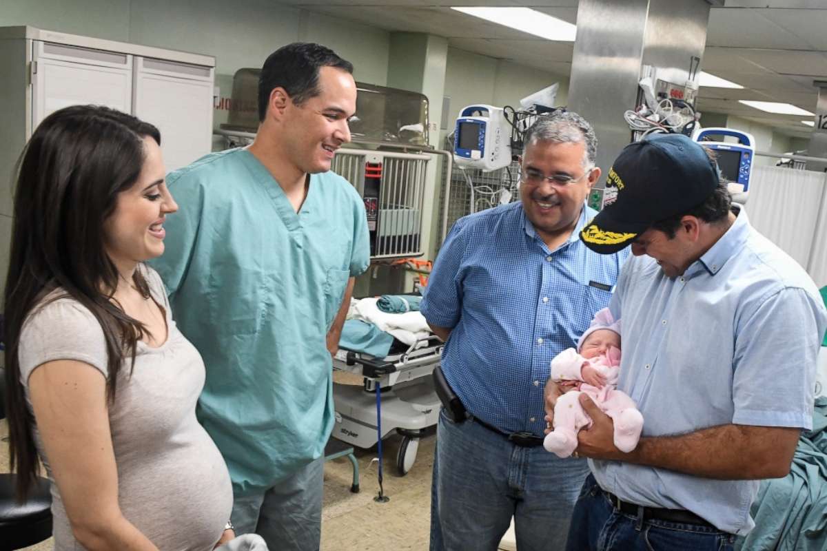PHOTO: Puerto Rico Gov. Ricardo Rossello (far right) holds Sara Victoria Llull Rodriguiz, the first child born aboard the USNS Comfort in more than seven years.