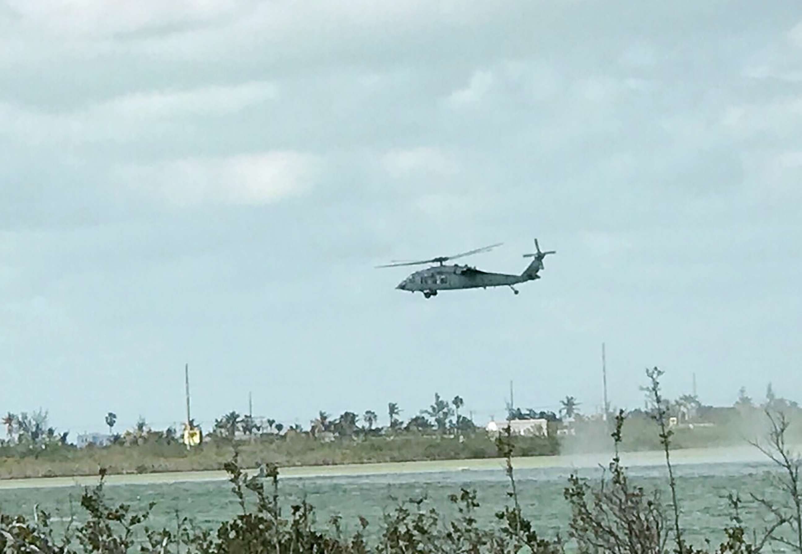 PHOTO: This photo obtained by ABC News shows a Navy SH-60 conducting search and rescue operations for a F/A-18 jet after it crashed off the coast of Key West, Fla., on March 14, 2018.