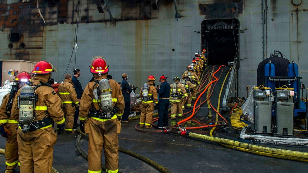 PHOTO: Sailors prepare to board the amphibious assault ship USS Bonhomme Richard (LHD 6) to fight an ongoing fire at Naval Base in San Diego, Calif. on Tuesday, July 14, 2020.