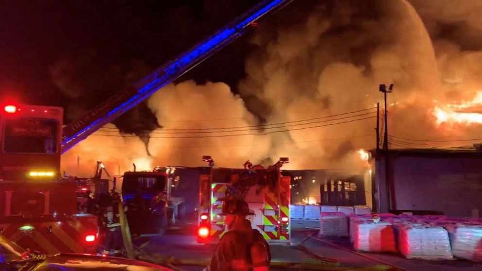 PHOTO: Firefighters battle a fire burning Weaver Fertilizer Plant burns on Cherry Street in Winston-Salem, N.C., Jan. 31, 2022.