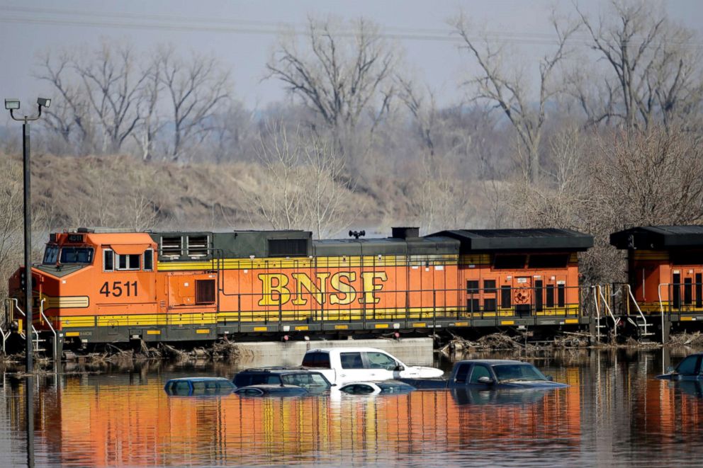 PHOTO: Cars sit in flood waters from the Platte River alongside a BNSF train, in Plattsmouth, Neb., March 17, 2019.