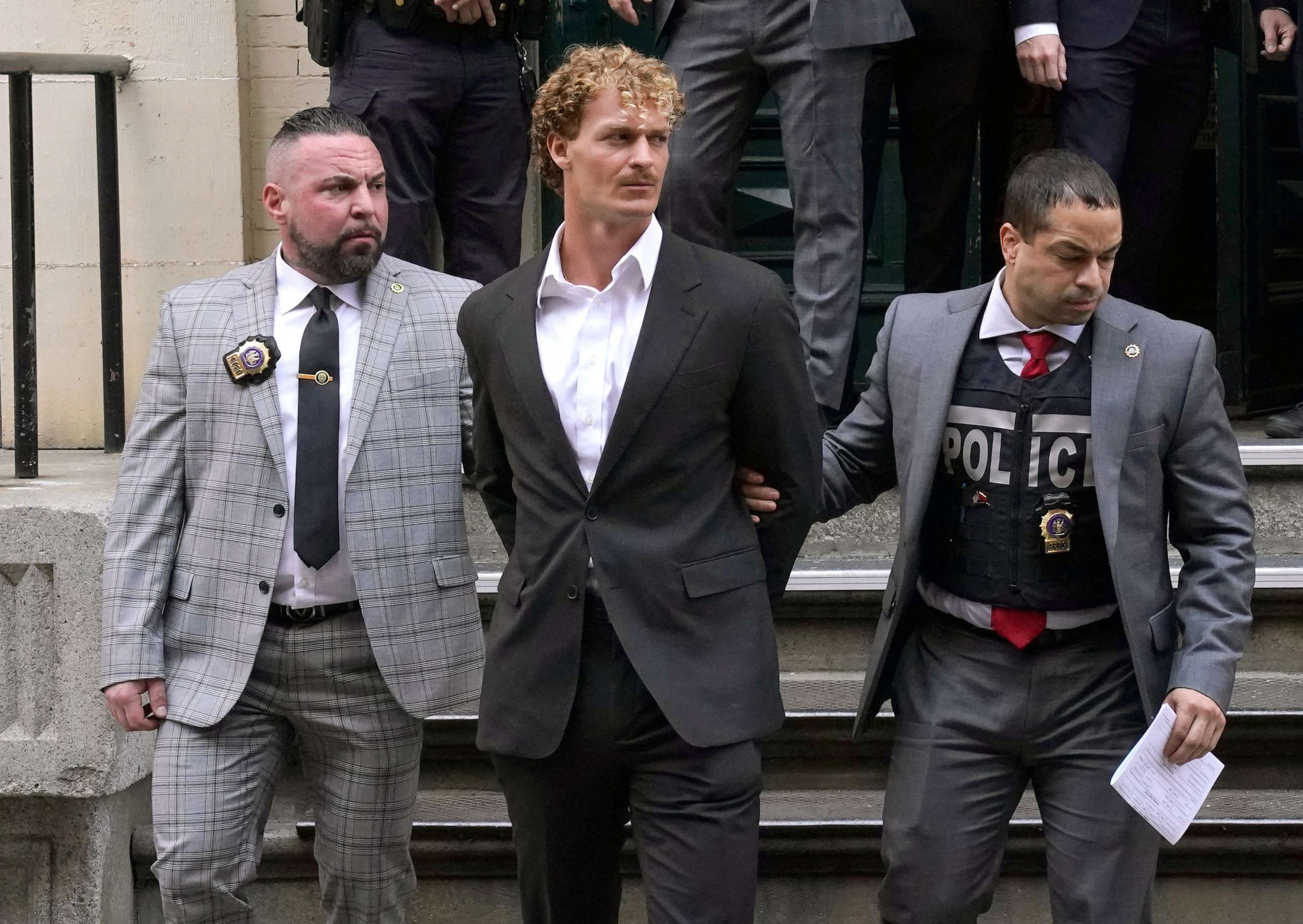 PHOTO: Daniel Penny, center, is walked out of the New York Police Department 5th Precinct in Lower Manhattan, May 12, 2023, after he surrendered to authorities after being charged with 2nd Degree Manslaughter in the chokehold death of Jordan Neely.