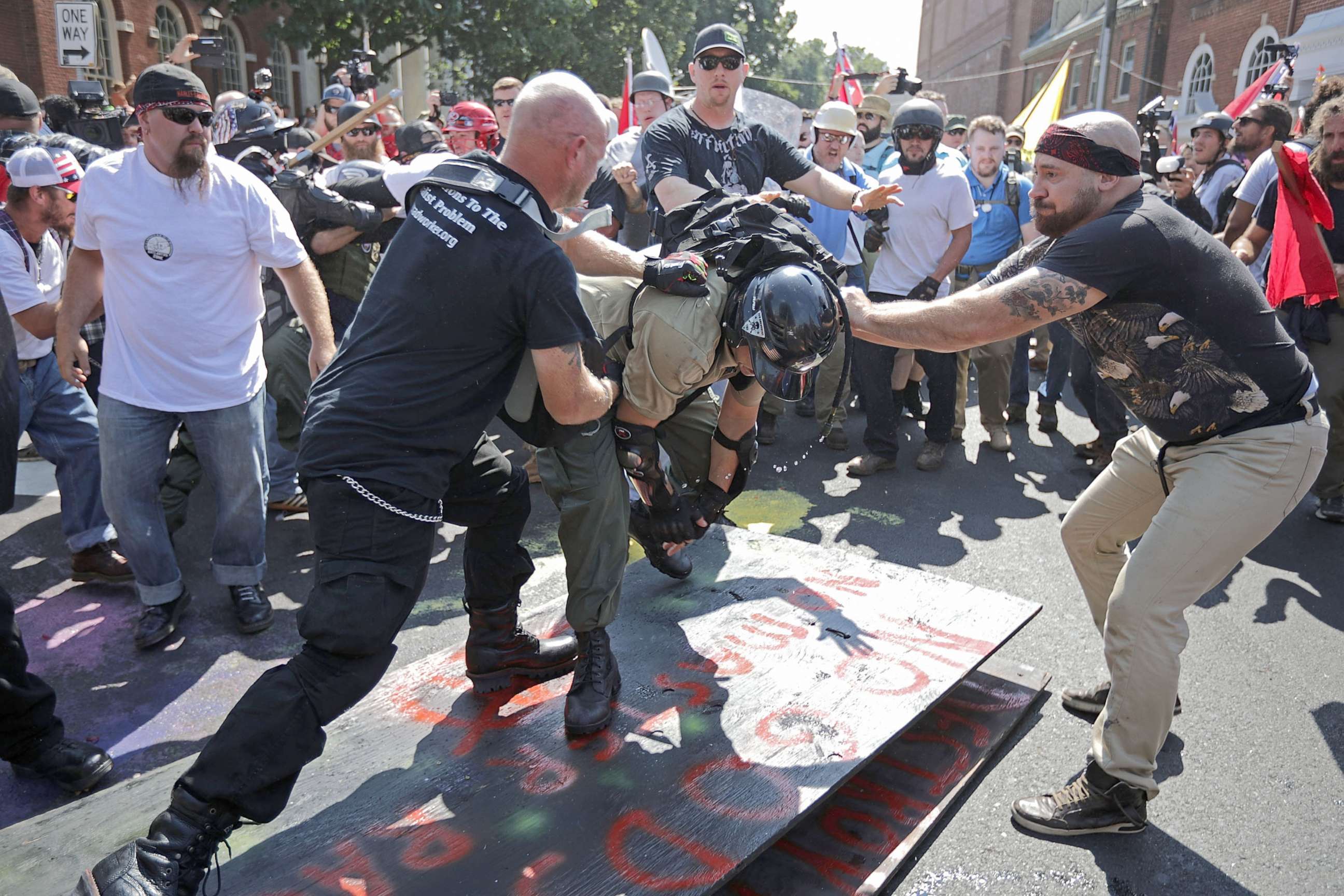 PHOTO: White nationalists, neo-Nazis, the KKK and members of the "alt-right" attack each other as a counter protester (R) intervenes during the melee outside Emancipation Park during the Unite the Right rally, Aug. 12, 2017, in Charlottesville, Va.
