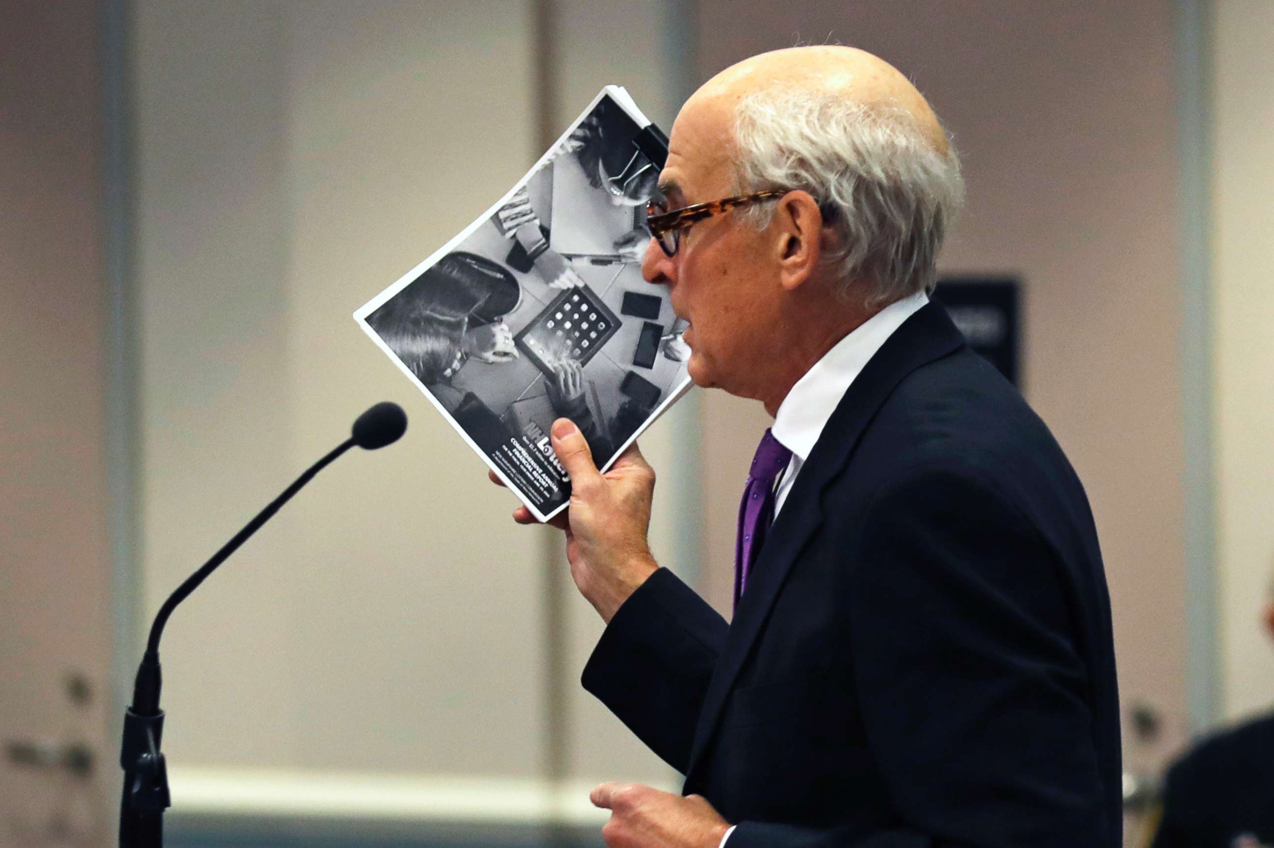 PHOTO: Attorney Steven M. Gordon, who represents lottery winner "Jane Doe", holds up an annual report from the New Hampshire Lottery during a hearing in the Jane Doe v. NH Lottery Commission case in Nashua, N.H., Feb. 13, 2018. 