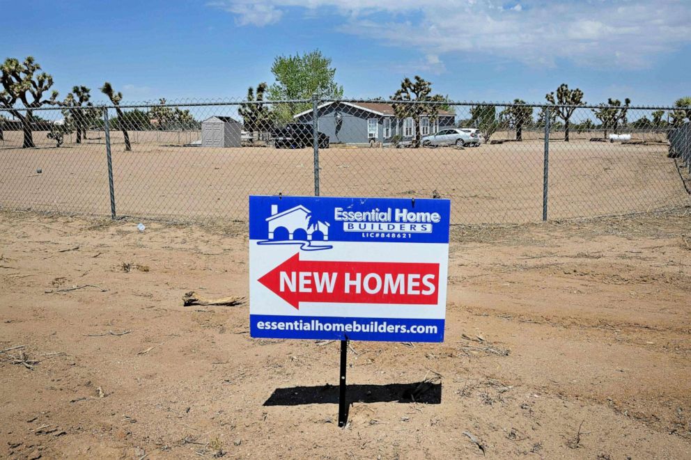 PHOTO: In this Aug. 18, 2022, file photo, a sign pointing to new housing in Hesperia, Calif.