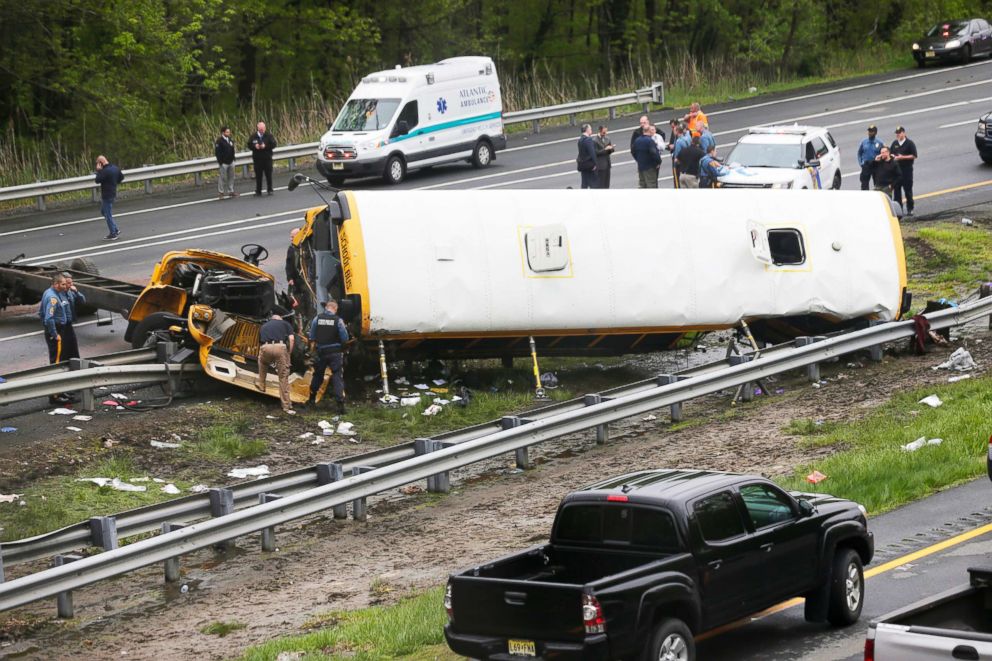 PHOTO: Emergency personnel work at the scene of a school bus and dump truck collision, injuring multiple people, on Interstate 80 in Mount Olive, N.J., on May 17, 2018.