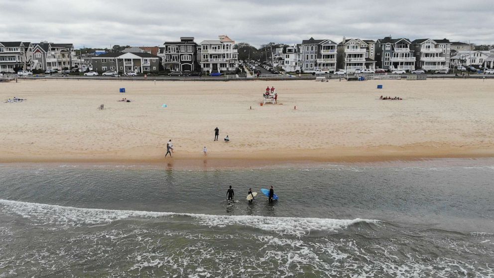 PHOTO: People visit the Jersey shore, May 23, 2020, in Belmar, N.J., during the coronavirus pandemic.