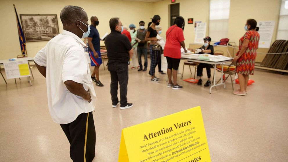 PHOTO: Voters wait in line to receive provisional ballots at a polling site in Hackensack, N.J., July 7, 2020.