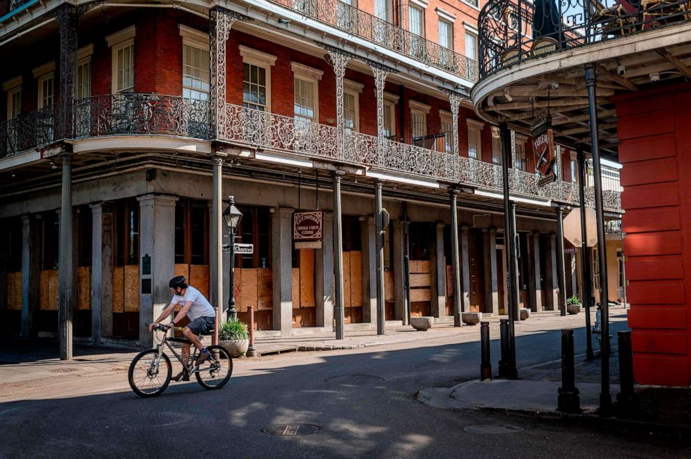 PHOTO: A man cycles along Jackson Square in New Orleans, Louisiana, on March 26, 2020.