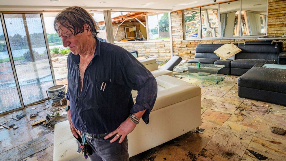 PHOTO: Eric Ehlenberger pauses as he goes through his damaged home in New Orleans on July 10, 2019, following a storm that swamped the city and paralyzed traffic.