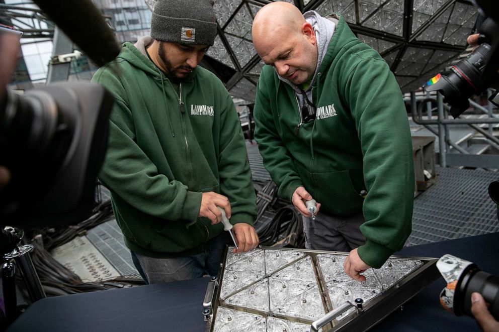 PHOTO: Workers install Waterford Crystal triangles on the Times Square New Year's Eve Ball on the roof of One Times Square in New York, Dec. 27, 2019.