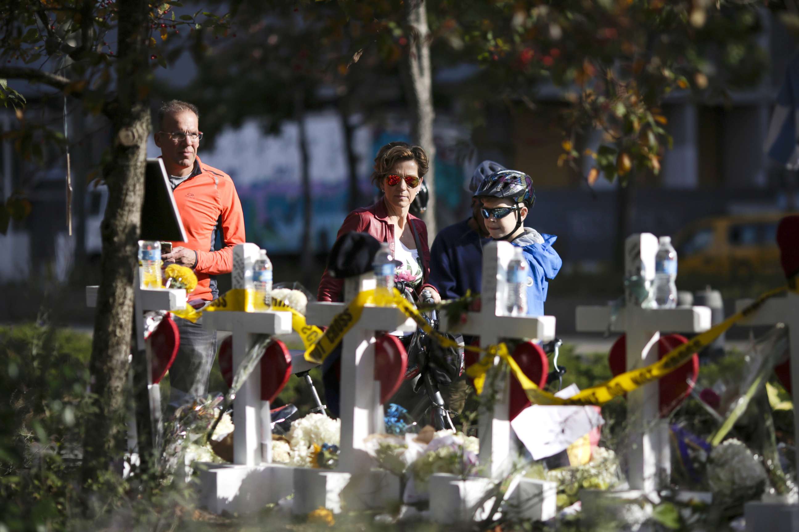 PHOTO: People take a look of the makeshift memorial for victims of Tuesday's terrorist attack along a bike path in lower Manhattan, Nov. 3, 2017, in New York City. 