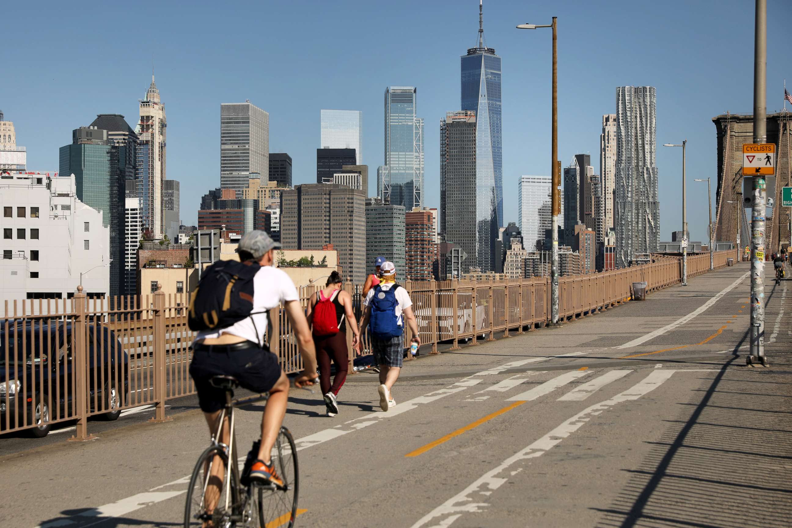 PHOTO: People ride their bikes across the Brooklyn Bridge as Manhattan enters Phase 2 of re-opening following restrictions imposed to curb the coronavirus pandemic on June 22, 2020 in New York City.