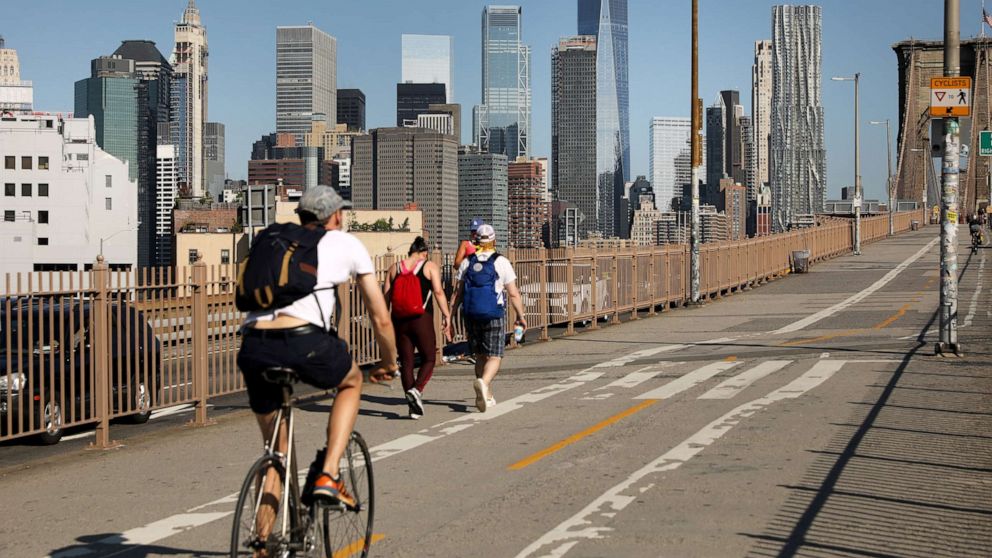 PHOTO: People ride their bikes across the Brooklyn Bridge as Manhattan enters Phase 2 of re-opening following restrictions imposed to curb the coronavirus pandemic on June 22, 2020 in New York City.