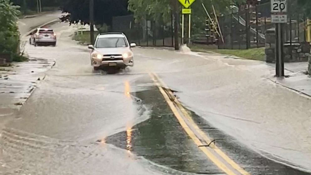 PHOTO: Cars drive on a flooded road in Highland Falls, Orange County, July 9, 2023 in this screengrab obtained from social media video.