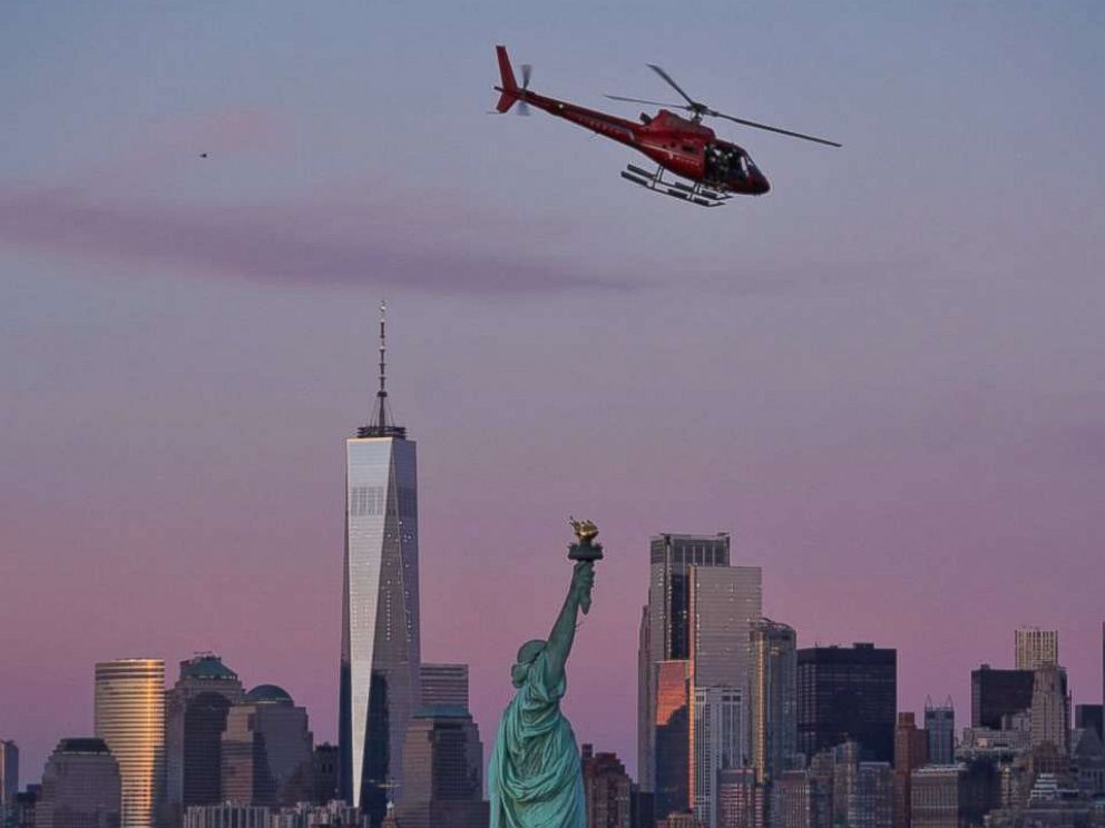 PHOTO: A chartered helicopter that later crashed into New Yorks East River flies past the Statue of Liberty in New York, March 11, 2018.