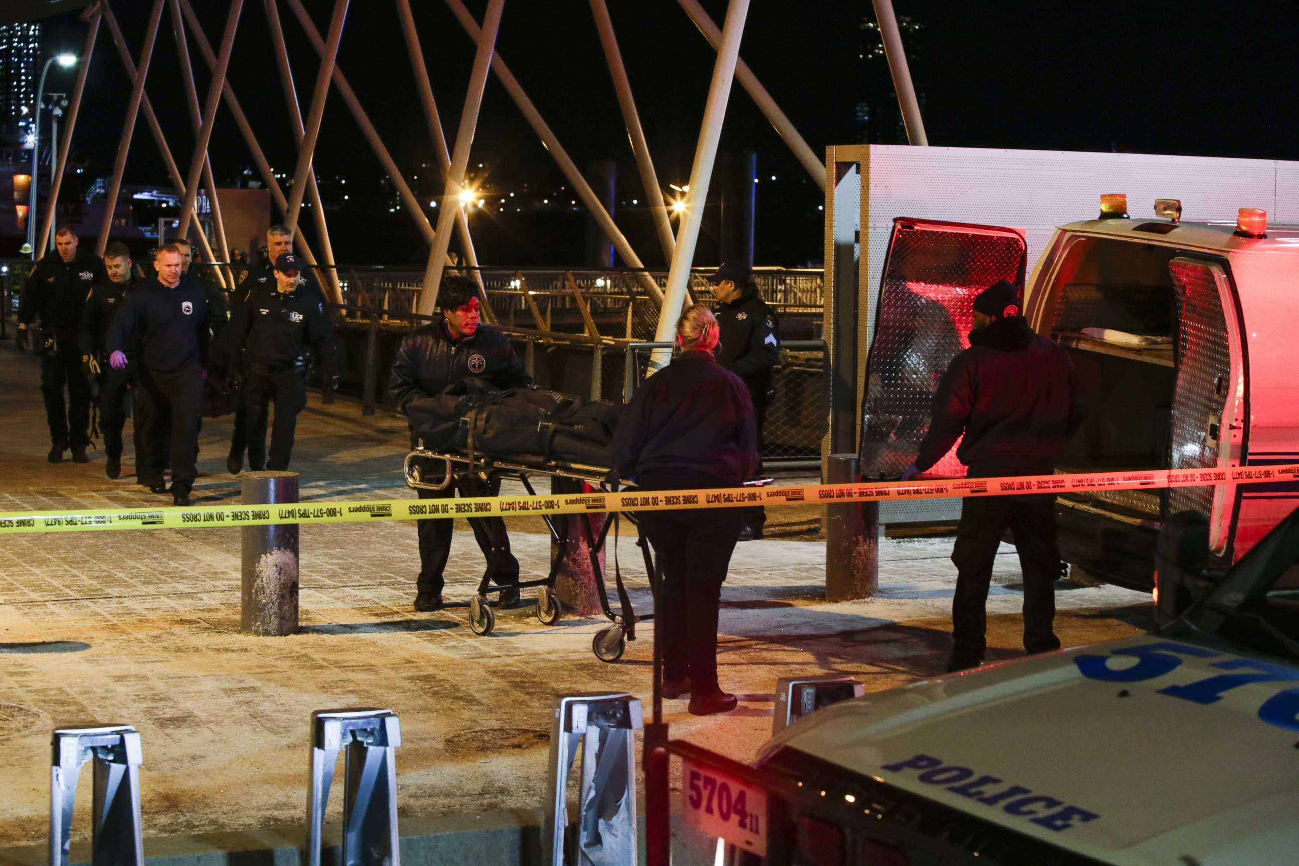 PHOTO: NYPD officers remove bodies from the scene of a helicopter crash in the East River on March 11, 2018 in New York.