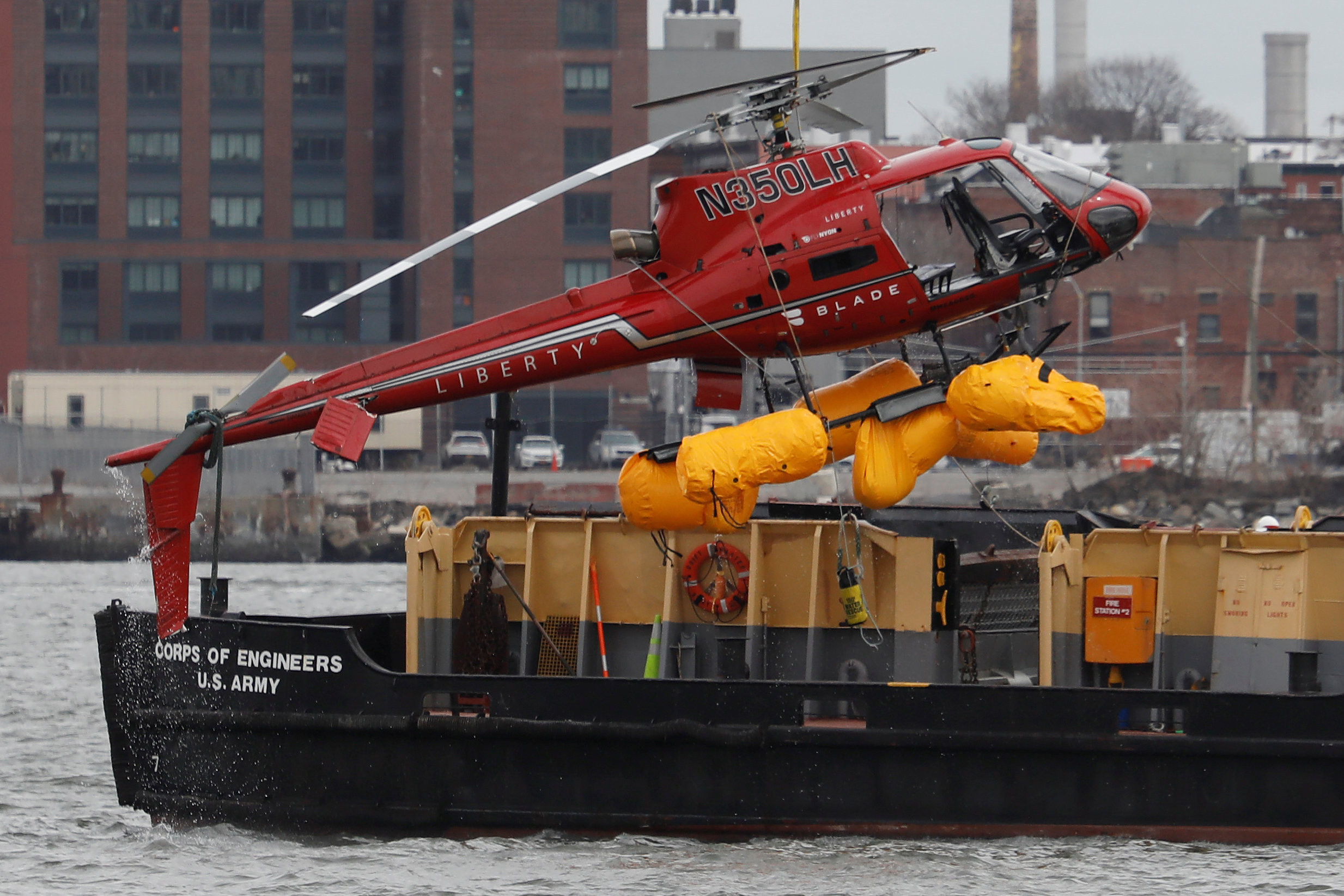 PHOTO: The wreckage of a chartered Liberty Helicopters helicopter that crashed into the East River is hoisted from the water in New York, March 12, 2018.