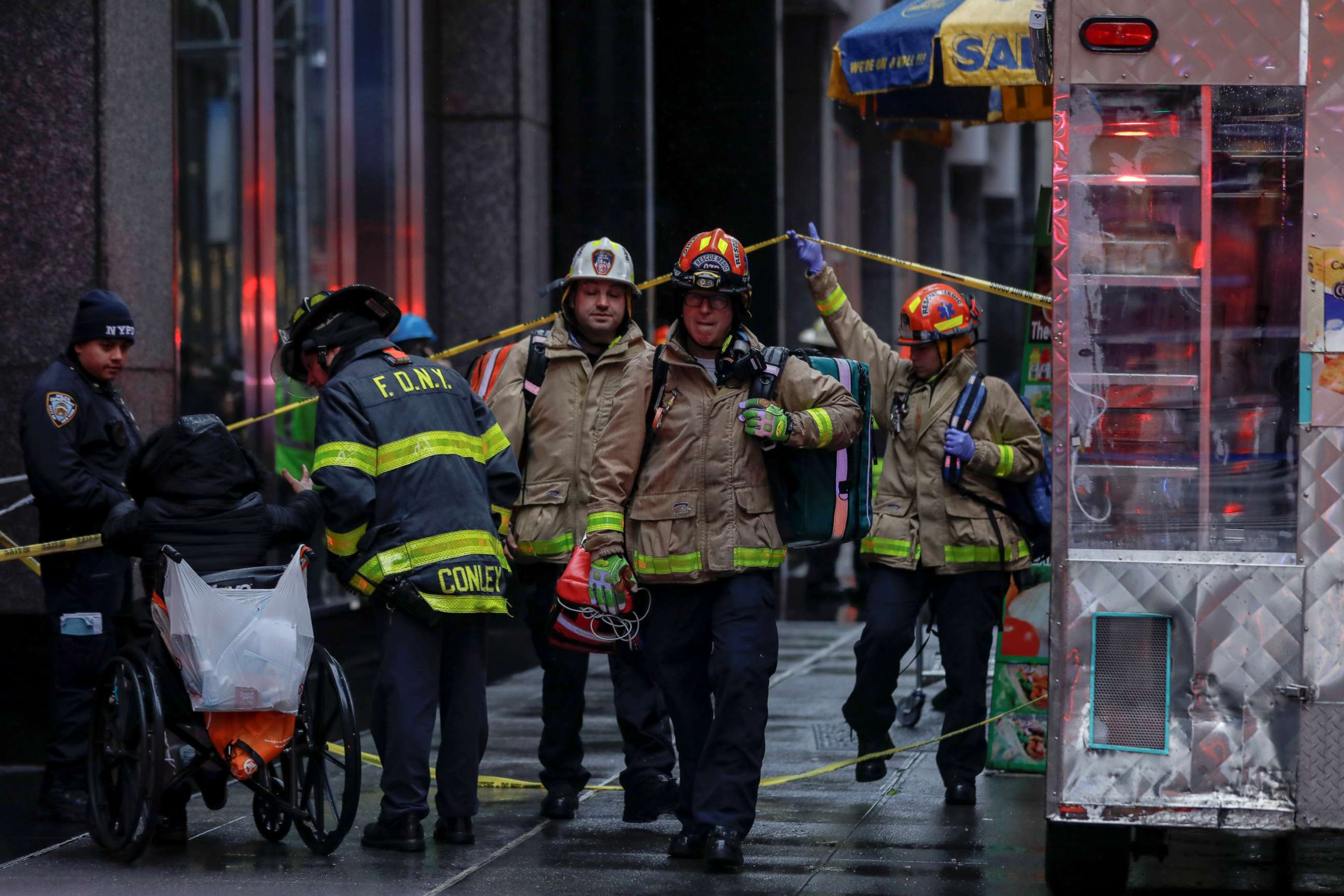PHOTO: Fire department and police department personnel work at the scene after a woman was killed by falling debris near Times Square in New York, Dec. 17, 2019.