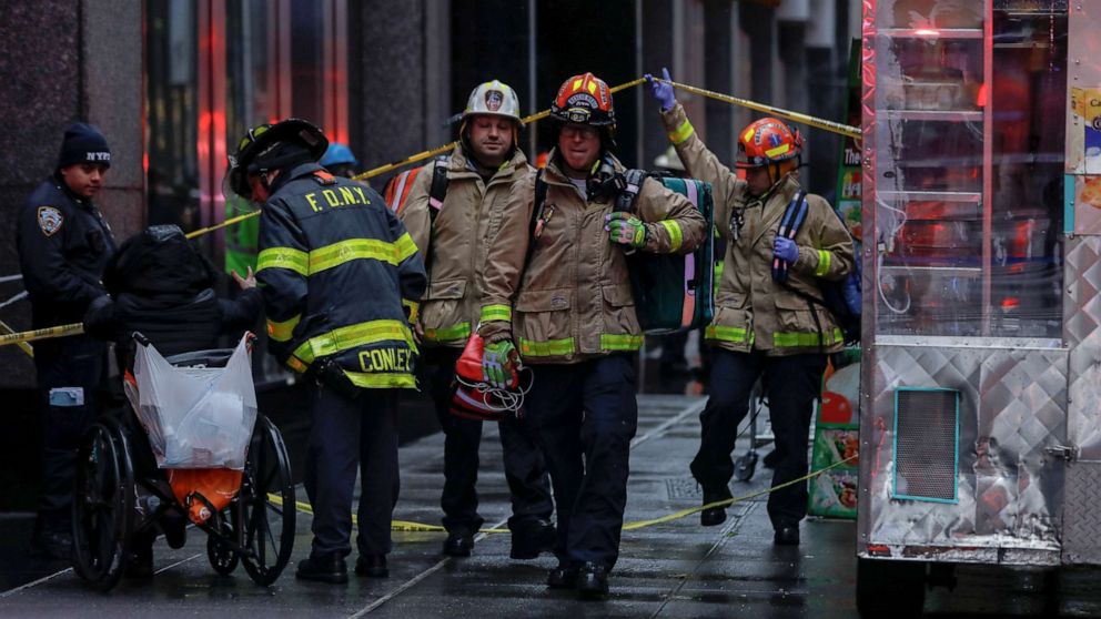 PHOTO: Fire department and police department personnel work at the scene after a woman was killed by falling debris near Times Square in New York, Dec. 17, 2019.