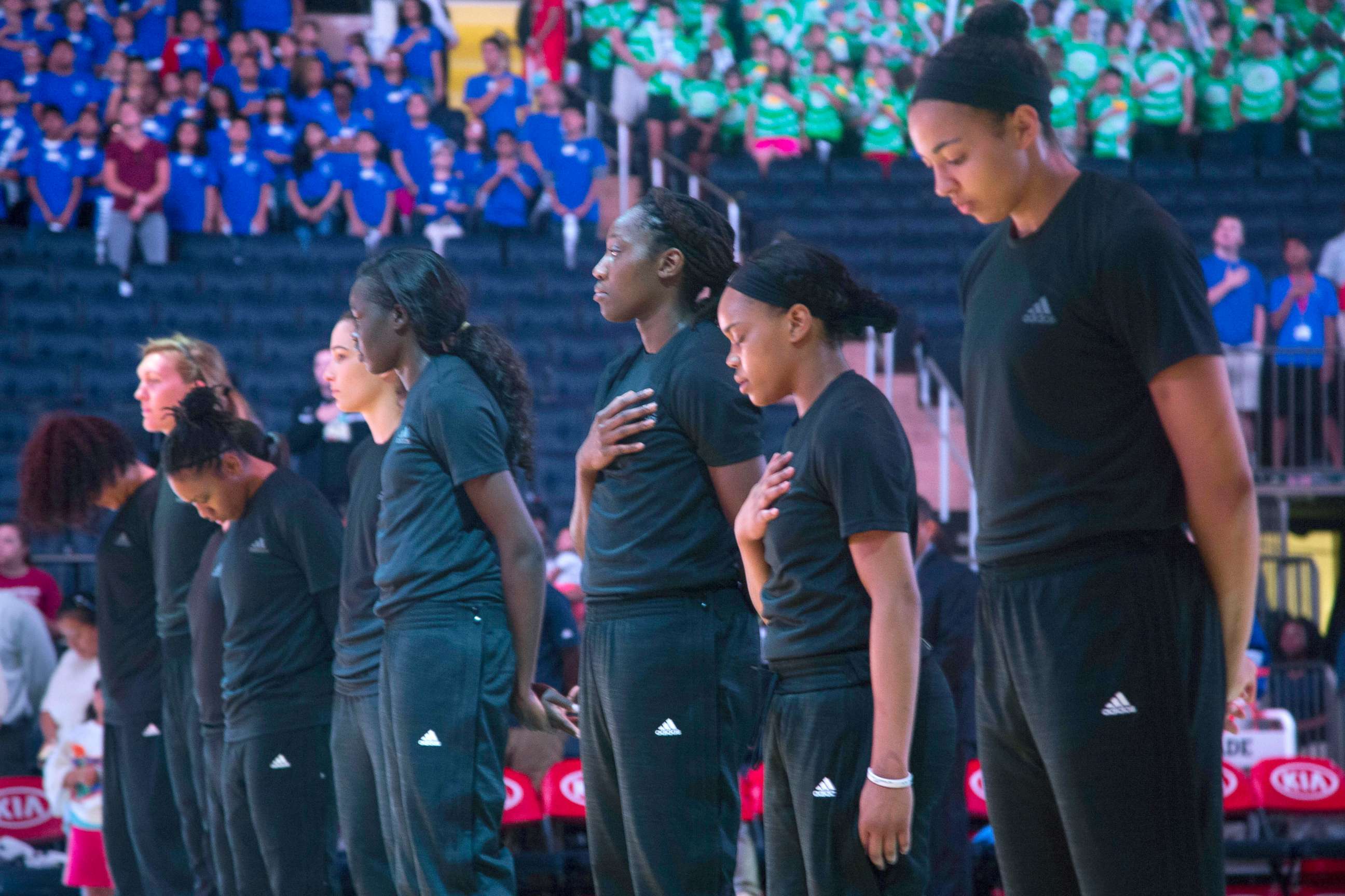 PHOTO: Members of the New York Liberty basketball team stand during the playing of the Star Spangled Banner prior to a game against the Atlanta Dream, July 13, 2016, in New York.