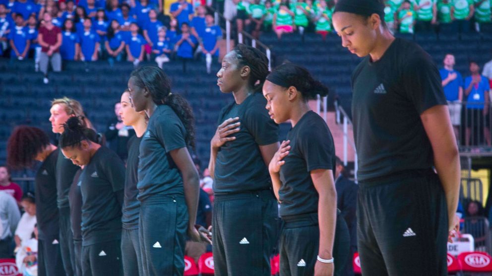 PHOTO: Members of the New York Liberty basketball team stand during the playing of the Star Spangled Banner prior to a game against the Atlanta Dream, July 13, 2016, in New York.