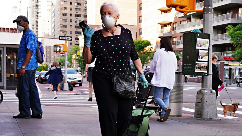 PHOTO: A woman walks while wearing a protective mask during the coronavirus pandemic, May 16, 2020 in New York City.