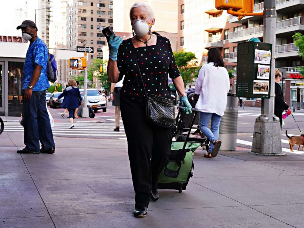 PHOTO: A woman walks while wearing a protective mask during the coronavirus pandemic, May 16, 2020 in New York City.