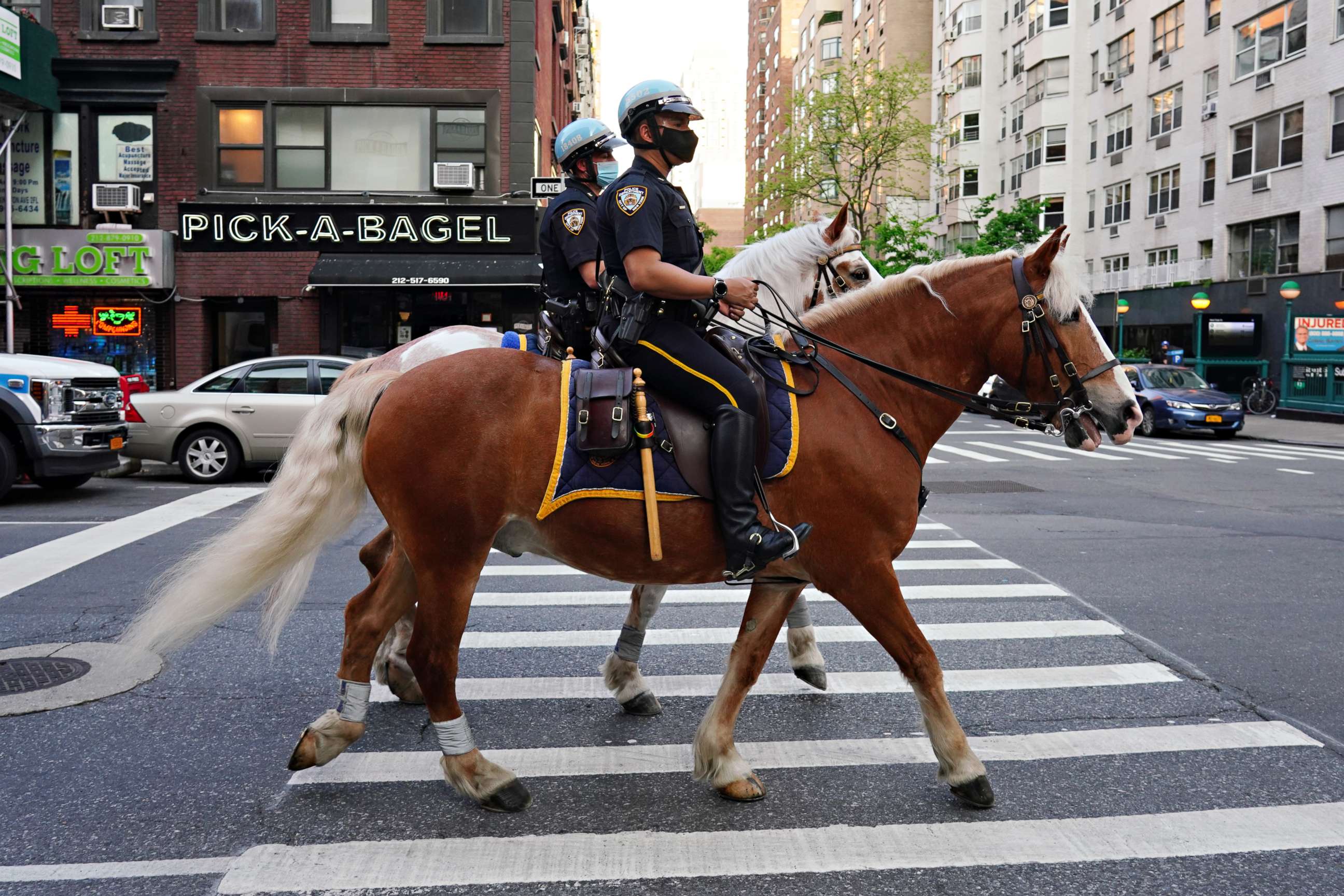 PHOTO: NYPD Mounted Unit officers ride up to Lenox Hill Hospital to show gratitude to the medical staff during the coronavirus pandemic on May 15, 2020 in New York City.