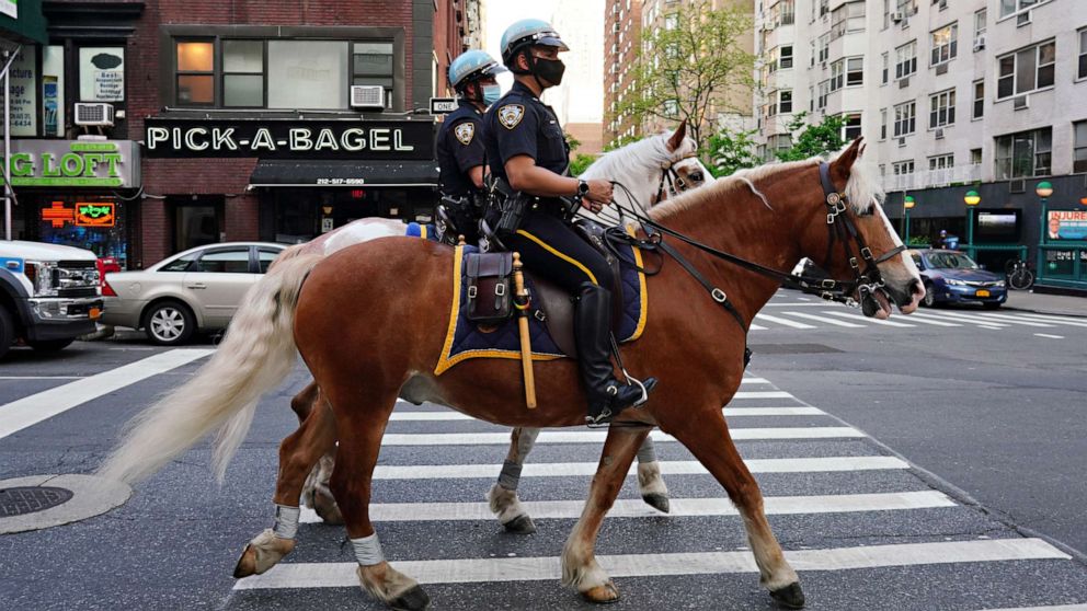 PHOTO: NYPD Mounted Unit officers ride up to Lenox Hill Hospital to show gratitude to the medical staff during the coronavirus pandemic on May 15, 2020 in New York City.