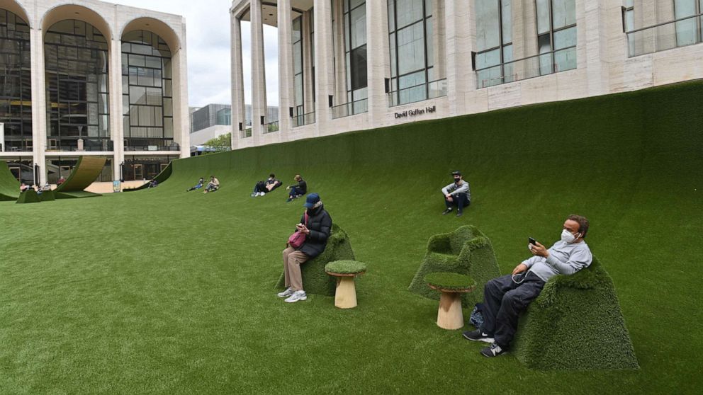 PHOTO: People wear masks at 'The Green' at Lincoln Center for the Performing Arts in New York, May 10, 2021.